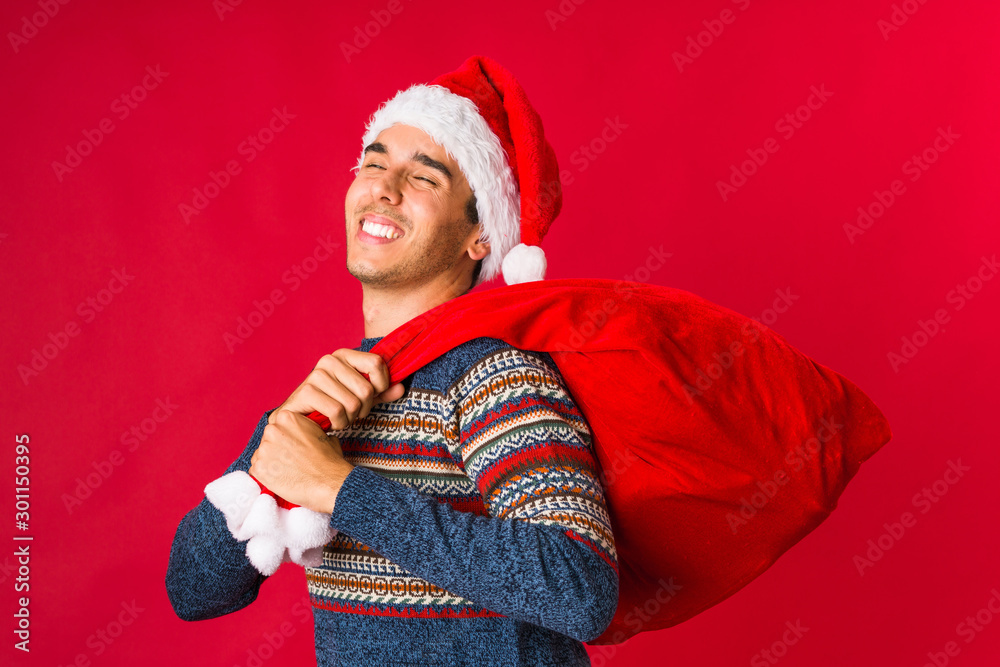 Young man holding a gift on christmas day Young man holding a gift on christmas day