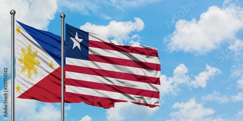 Philippines and Liberia flag waving in the wind against white cloudy blue sky together. Diplomacy concept  international relations.