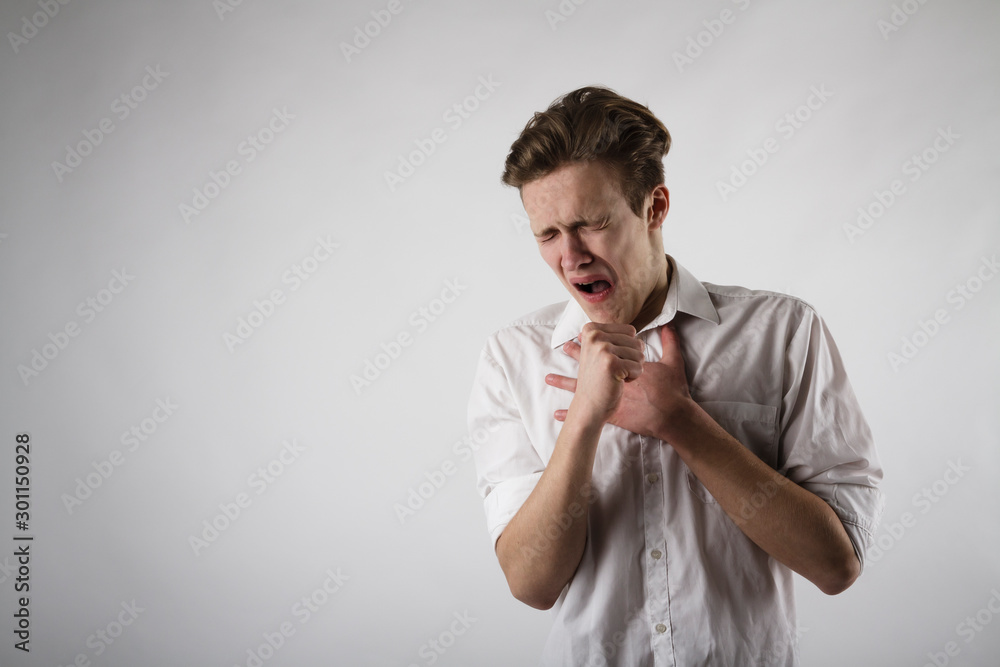 Young man in white is coughing. Young man in white is coughing.