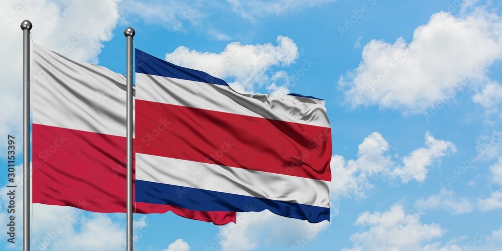Poland and Costa Rica flag waving in the wind against white cloudy blue sky together. Diplomacy concept, international relations.