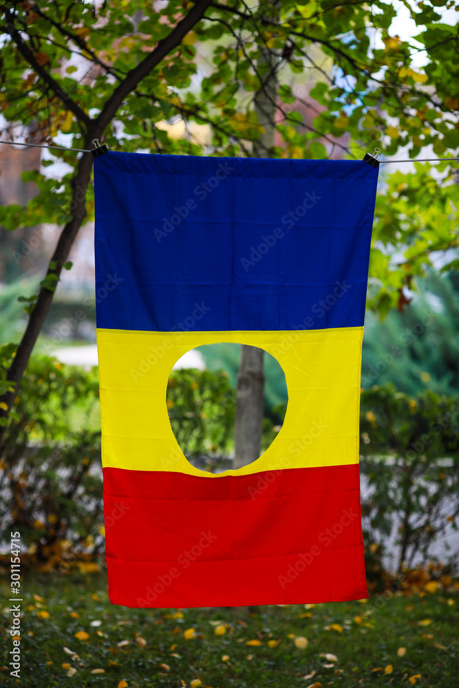 Details with the Romanian flag with a hole, the symbol of the Romanian ...