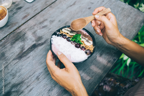 Person enjoying delicious dessert outside cafe