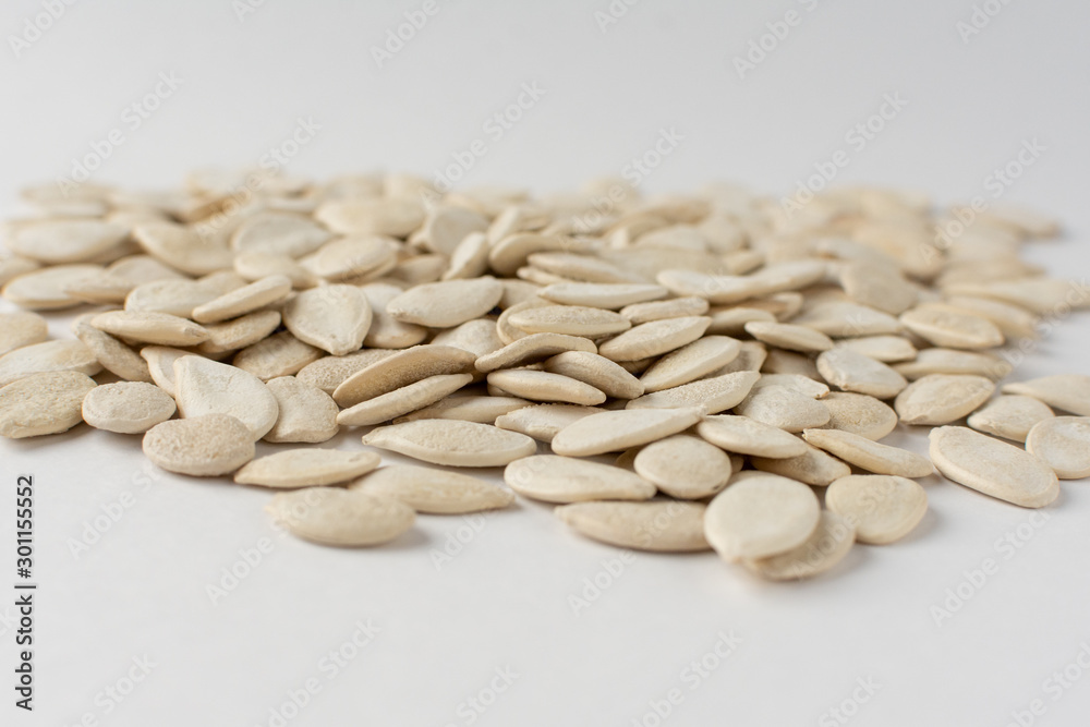 Roasted pumpkin seeds with salt on white background. Roasted pumpkin seeds with salt on white background.