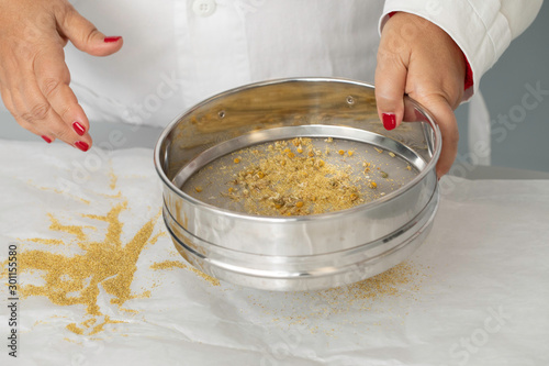 Wallpaper Mural Woman sifting chamomile close up Torontodigital.ca