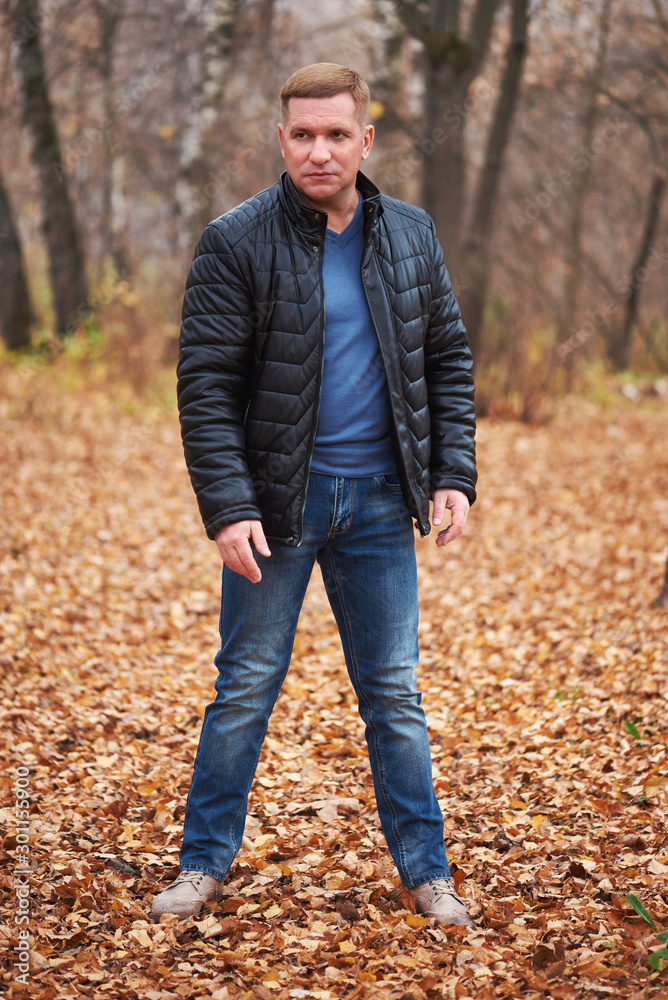 Middle aged man in the autumn park Middle aged man in the autumn park