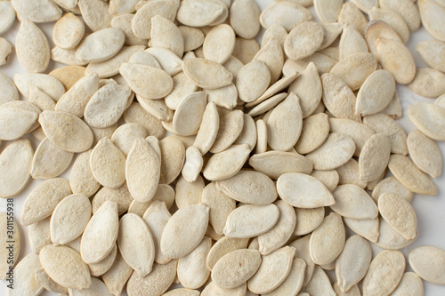 Obraz na plátně Roasted pumpkin seeds with salt on white background.
