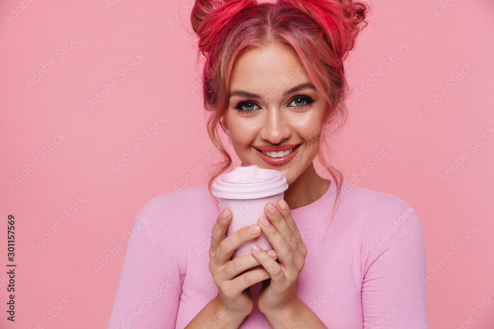 Portrait of young woman in t-shirt smiling and holding takeaway paper cup Portrait of young woman in t-shirt smiling and holding takeaway paper cup