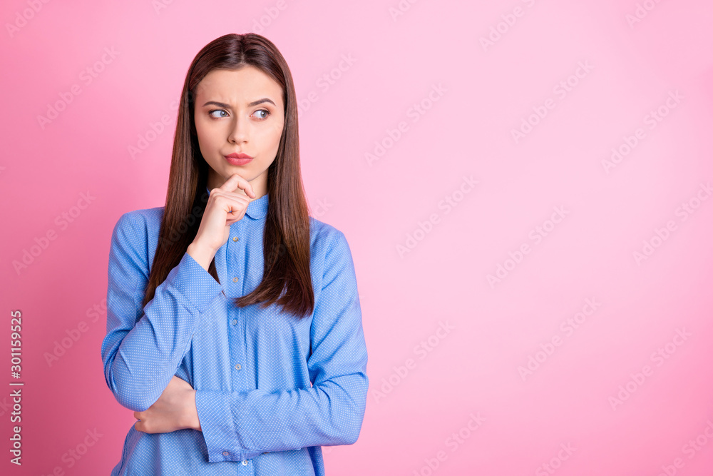 Photo of interested young ceo planning development of her company wearing blue shirt isolated over pink pastel background Photo of interested young ceo planning development of her company wearing blue shirt isolated over pink pastel background