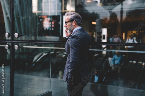 Businessman talking on phone in fitting well suit