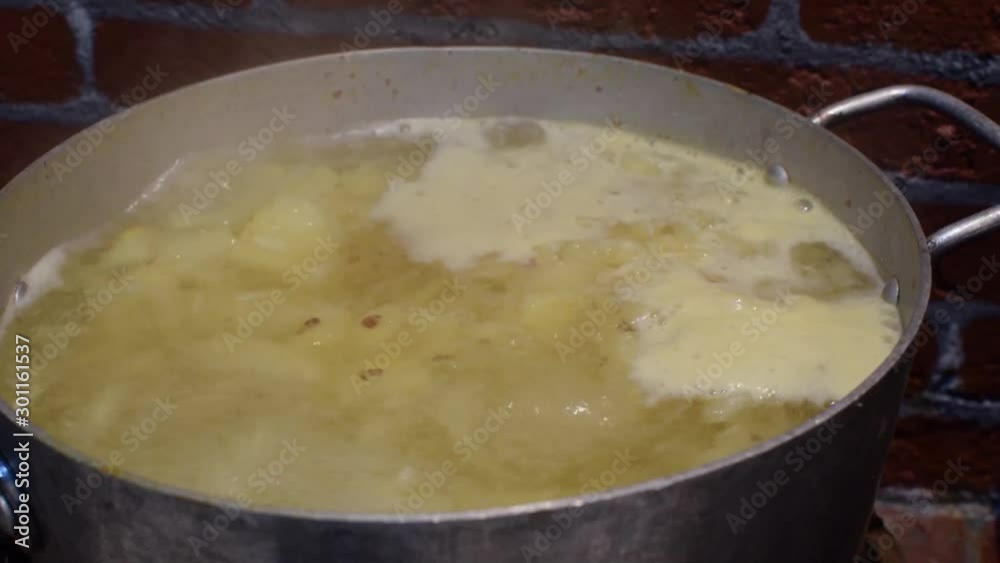 Cooking pineapple fruit in boiling water making home made wine Cooking pineapple fruit in boiling water making home made wine