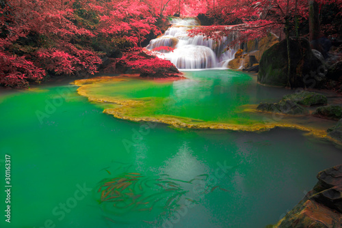 Hot Springs Onsen Natural Bath Surrounded by red-yellow leaves.Waterfalls in the emerald blue water in Erawan National Park.beautiful natural rock waterfall in Kanchanaburi, Thailand.Onsen atmosphere.