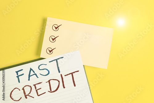 Conceptual hand writing showing Fast Credit. Concept meaning Apply for a fast demonstratingal loan that lets you skip the hassles Empty orange paper with copy space on the yellow table