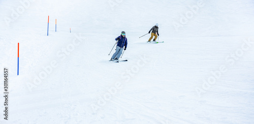 Young couple skiing on high snow mountains during winter vacation - Athletes training doing extreme sport - Travel, holidays and ski track concept - Focus on man body