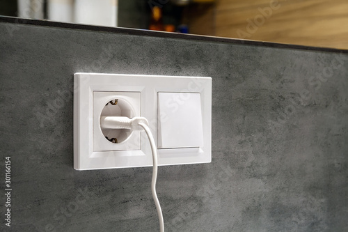 Foto A closeup diagonal view of a group of white european electrical outlet with a pl