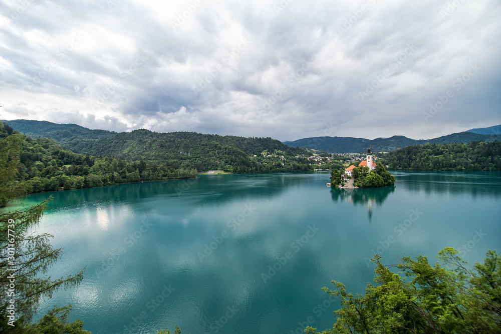 Bled, Slovenia - July, 2019: Bled church with lake, island and mountains in background, Slovenia, Europe