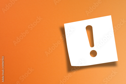  Note paper with exclamation mark on orange background 