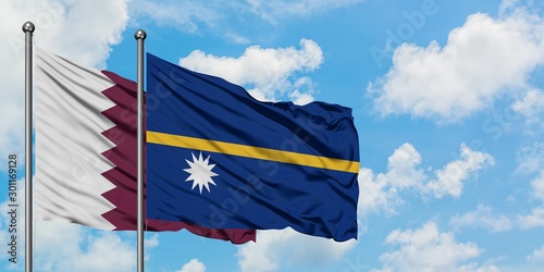 Qatar and Nauru flag waving in the wind against white cloudy blue sky together. Diplomacy concept, international relations.