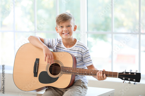 Little boy playing guitar n...