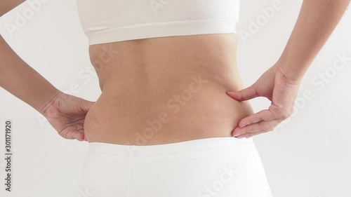 cellulite in woman and she grabbing her hip cause of fatty from weight and loss of collagen use for body firming gel or cream product or liposuction concept photo