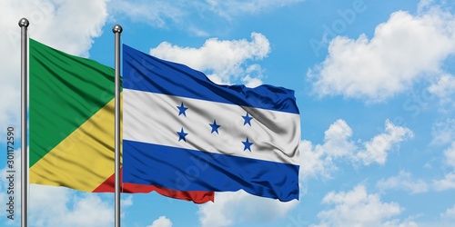 Republic Of The Congo and Honduras flag waving in the wind against white cloudy blue sky together. Diplomacy concept, international relations.