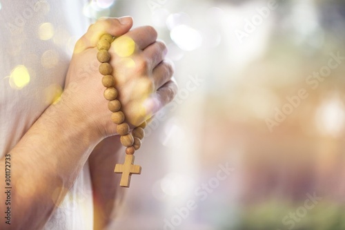 Hands of human praying on blurred background © BillionPhotos.com