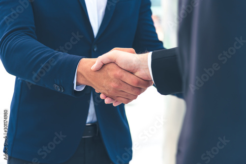 Two businessman shake hand for the first meeting. Two business people greeting outdoor. photo