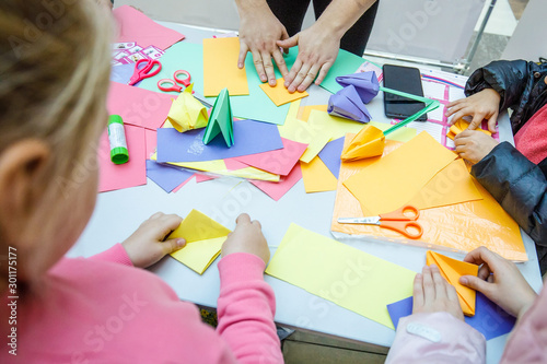 Children make paper origami
