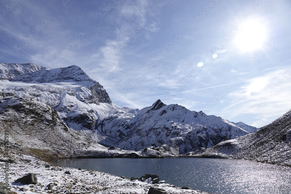 a beautiful mountain lake in the snow capped alps in autumn on a sunny 