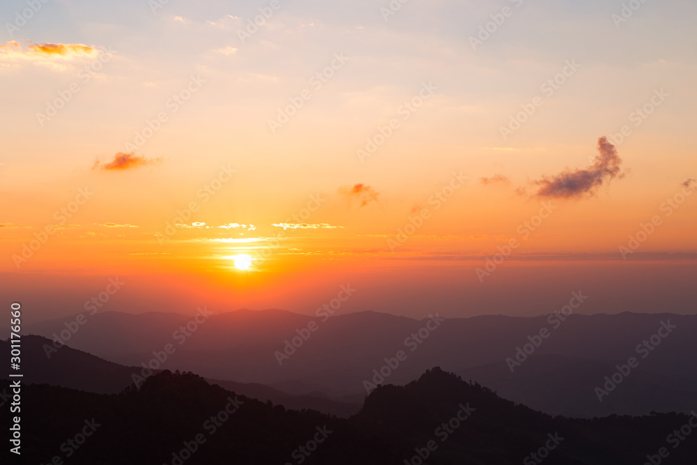 Fototapeta premium Colorful color clear sky with cloud and silhouette mountains at dawn time before sunrise, take photo from top of mountain in Thailand