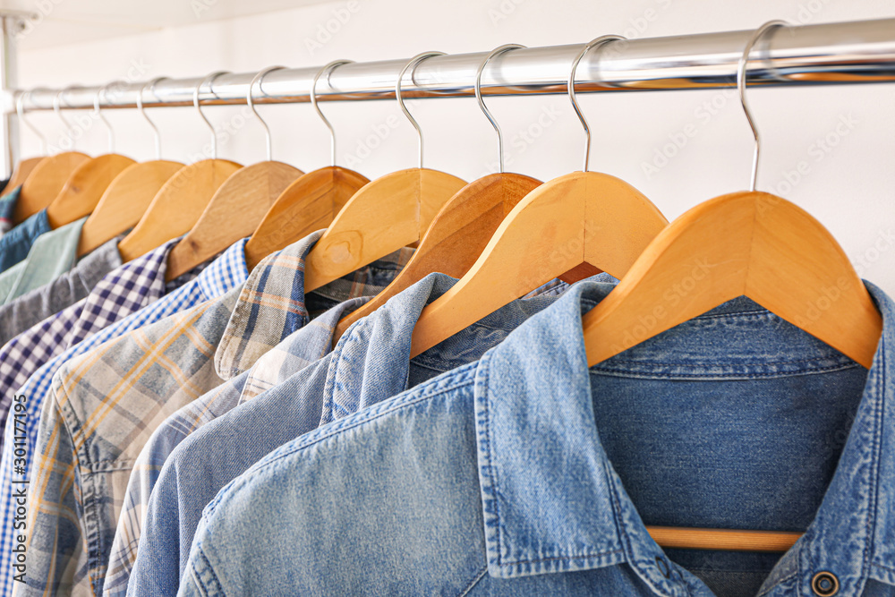 Stylish clothes on hangers in show room, closeup Stylish clothes on hangers in show room, closeup