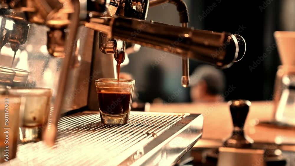 4K Brewing the espresso coffee from the machine warm tone.