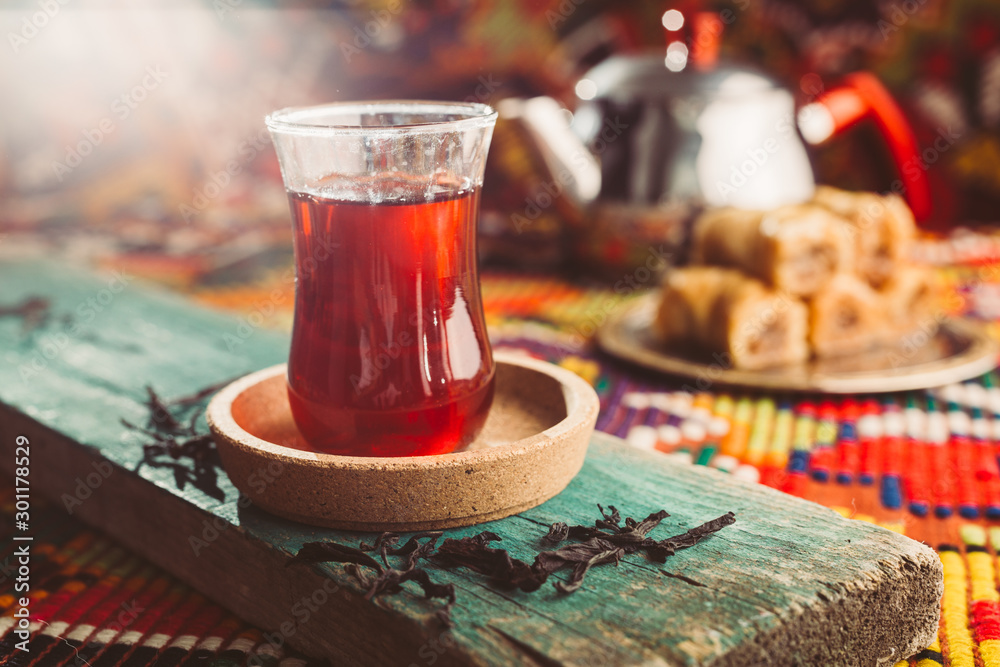 delicious turkish tea and baklava on colorful rug - obrazy, fototapety, plakaty 