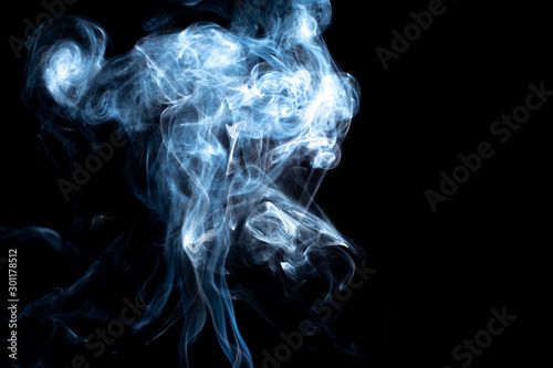 Colorful smoke on dark background. © thanakit