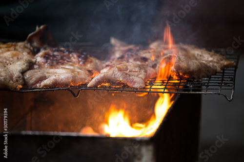 Roast pork on a charcoal flame.
