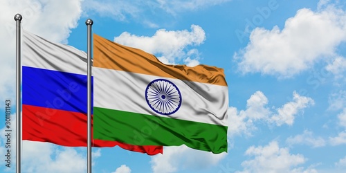 Fotografía Russia and India flag waving in the wind against white cloudy blue sky together