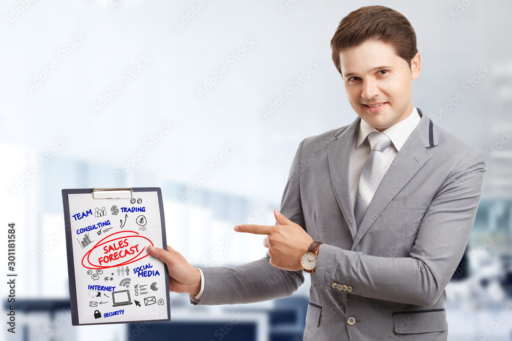 Planning marketing strategy. Business, Technology, Internet and network concept. Young businessman shows the word: Sales forecast Planning marketing strategy. Business, Technology, Internet and network concept. Young businessman shows the word: Sales forecast