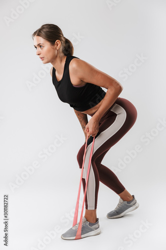 Image of athletic woman doing workout with expander equipment