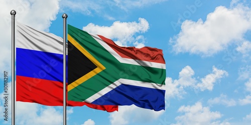Russia and South Africa flag waving in the wind against white cloudy blue sky together. Diplomacy concept  international relations.
