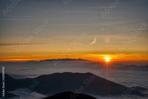 Mist flood the valley and mountains at the beautiful sunrise, slovakia, great rozutec