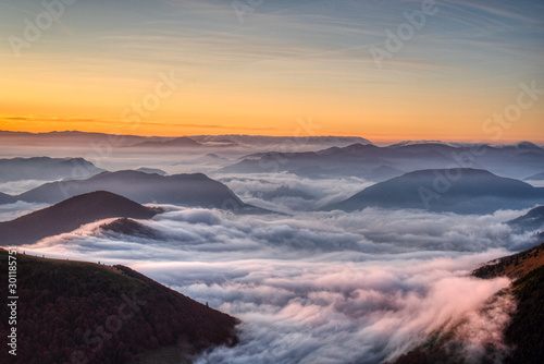 Mist flood the valley and mountains at the beautiful sunrise, slovakia, great rozutec