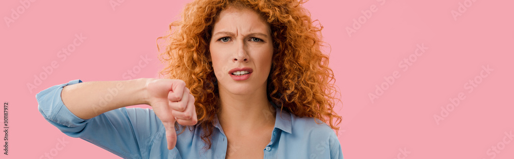 redhead woman showing thumb down Isolated On pink redhead woman showing thumb down Isolated On pink