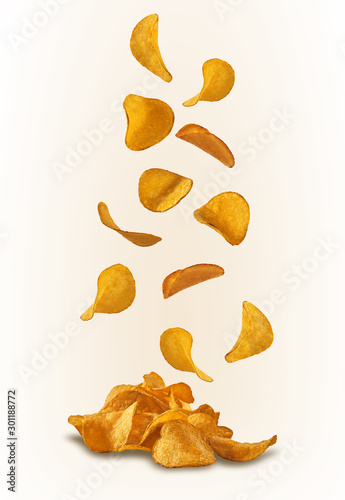 Potato crisps falling down, isolated on white background with copy space for text or images. Crispy, palatable chips. Advertising. Close-up. photo