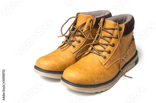 Closeup of orange leather boots for men on white background