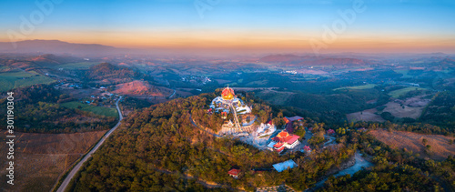 Top view Aerial photo from flying drone.The beautiful of Thai temple (Wat Pa Phu Hai Long) on the top of mountain in Pak Chong District,Nakorn Ratchasima, Thailand. © noon@photo