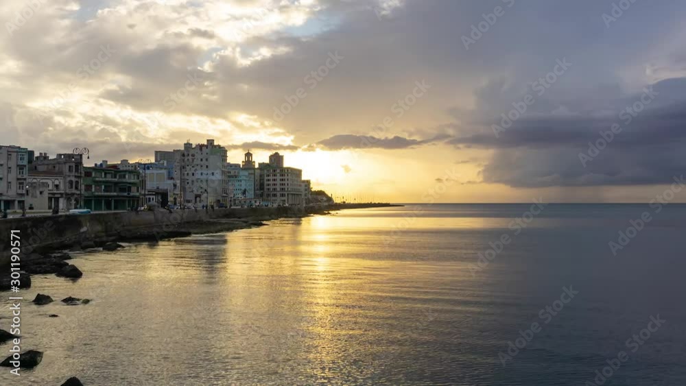 Beautiful Time Lapse of the Old Havana City, Capital of Cuba, by the ocean coast during a dramatic cloudy sunset. Beautiful Time Lapse of the Old Havana City, Capital of Cuba, by the ocean coast during a dramatic cloudy sunset.