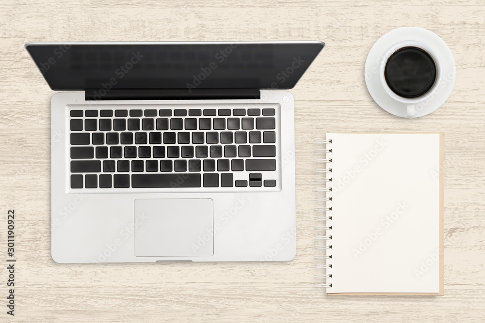 Laptop computer and blank notebook on wood table. Top view business background. Laptop computer and blank notebook on wood table. Top view business background.
