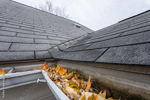 gutters are full of fall leaves and ice