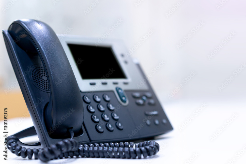 close up telephone VOIP technology standing on office desk in office room with copy space white color background for network operation center job concept