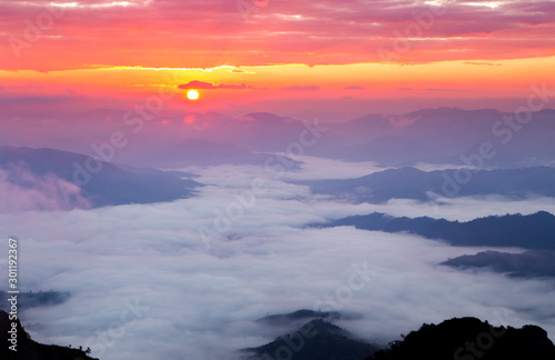 Colorful pastel color clear sky with sea of mist and cloud and silhouette mountains at twilight time before sunset, take photo from top of mountain in Thailand