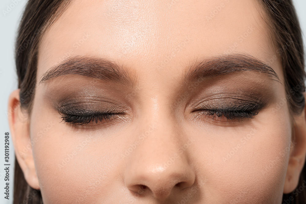 Young woman with beautiful eyebrows, closeup Young woman with beautiful eyebrows, closeup